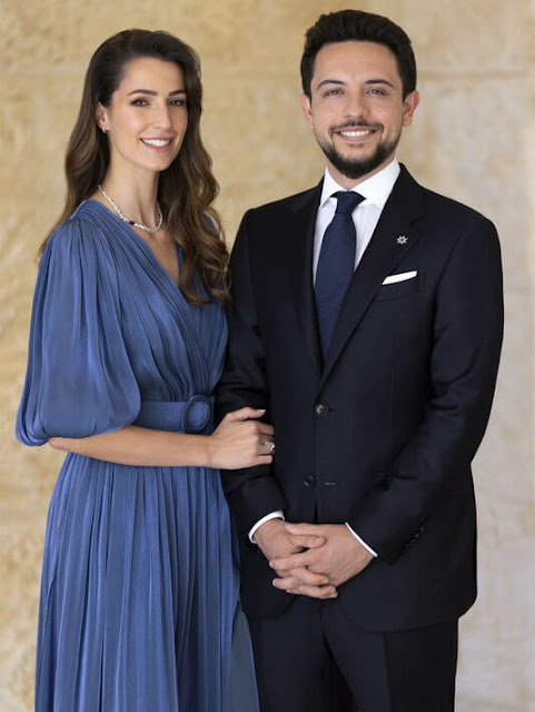 Rajwa Al Saif wore an embellished belted midi dress by Andrew Gn, and floral skirt by Sara Roka, and navy lurex dress by Costarellos