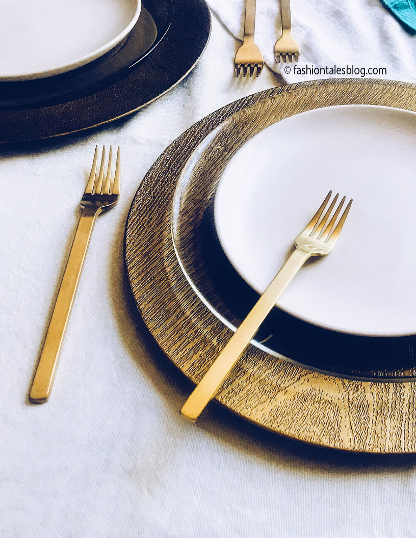 Gold flatware on white plate