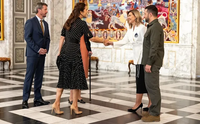 Crown Princess Mary wore a black polka-dot pleated dress by Prada. First Lady Olena Zelenska and President Volodymyr Zelensky