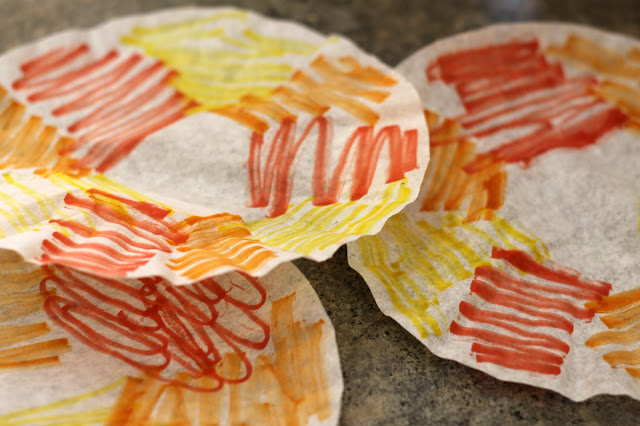 Fall tree craft for kids made from an empty cardboard tube and coffee filters