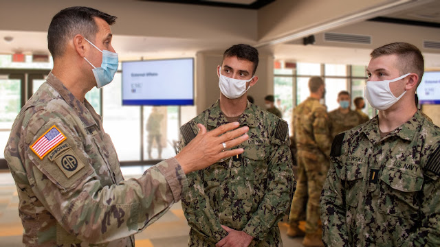 USU School of Medicine Command Army Col. (Dr.) Jay Dintaman (left) has a discussion with new class of 2026 students. (Photo by MC3 Brooks Smith, U.S. Navy)