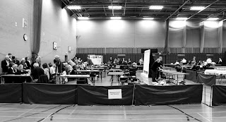 Sports Hall with people counting the votes