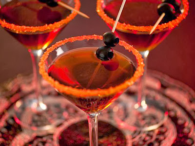 Dark rum and a black olive garnish make up a great cocktail named Black Devil Martini. Remember to rim the glass with coarse orange sugar to dress it up for a Halloween party. 
