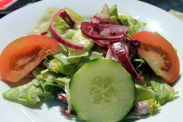 Lettuce salad with tomato, cucumber, and red onions