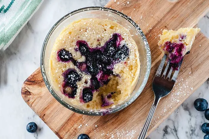 How to make a blueberry mug cake recipe.  This easy dessert for one person can be made in the microwave. Make a yummy quick individual dessert in a mug. This single serve recipe makes a mini cake for one person.  Make the best simple blueberry cake recipe in just a few minutes. #blueberry #mugcake #dessert