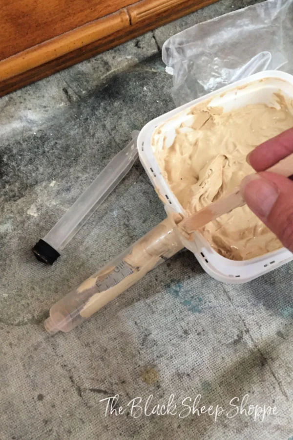 Put the wood filler in a small syringe.