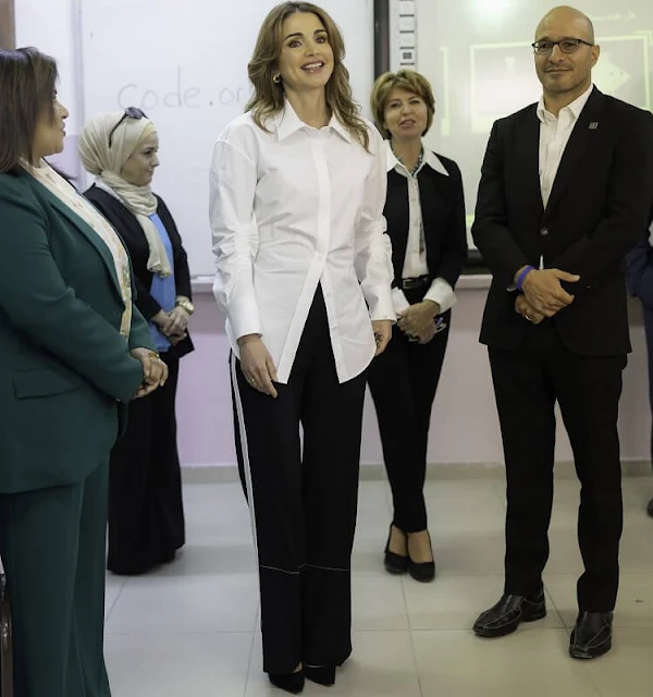 Queen Rania wore cinched poplin button-down shirt by Alexander Wang, and white side stripes wide-leg trousers by Proenza Schouler