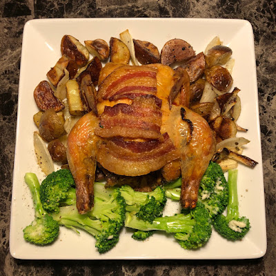 Cornish game hen stuffed with pineapple and thyme, topped with bacon, with roasted potatoes and broccoli