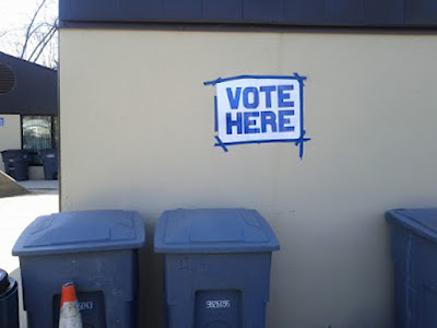 Trash cans marked 'VOTE HERE'