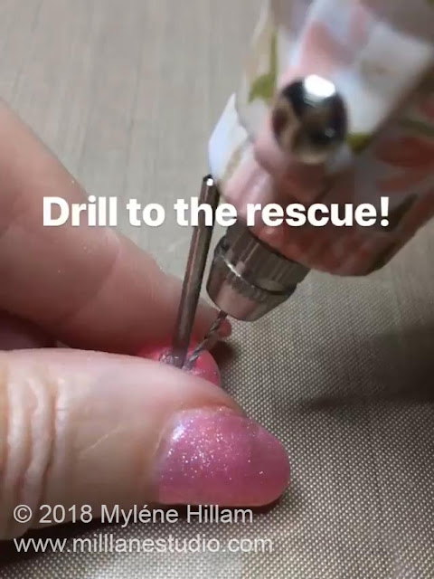 Using the drill to remove the resin alongside the shaft of the ball tool.
