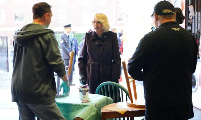 Queen Camilla wore a dark brown wool midi coat by Max Mara. The Queen visited Childrens Hospice. Emmaus charity