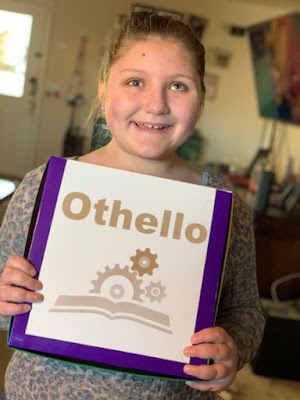 Portrait of Isabelle Harris smiling, holding box of Othello game