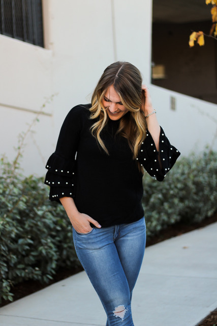 girl smiling, wearing black shein accent sleeve sweater