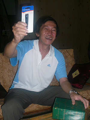 grandfather laughing and holding up the nail clipper