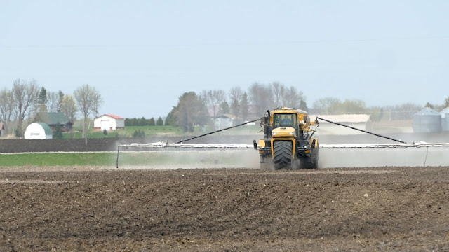 farm equipment applying fertilizer