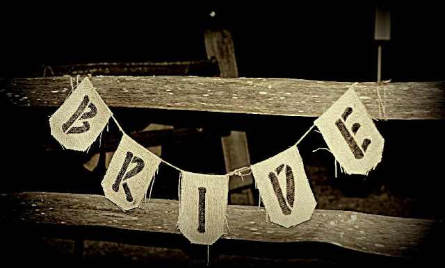 Rustic burlap Bride and Groom banners were placed on the fencing signifying
