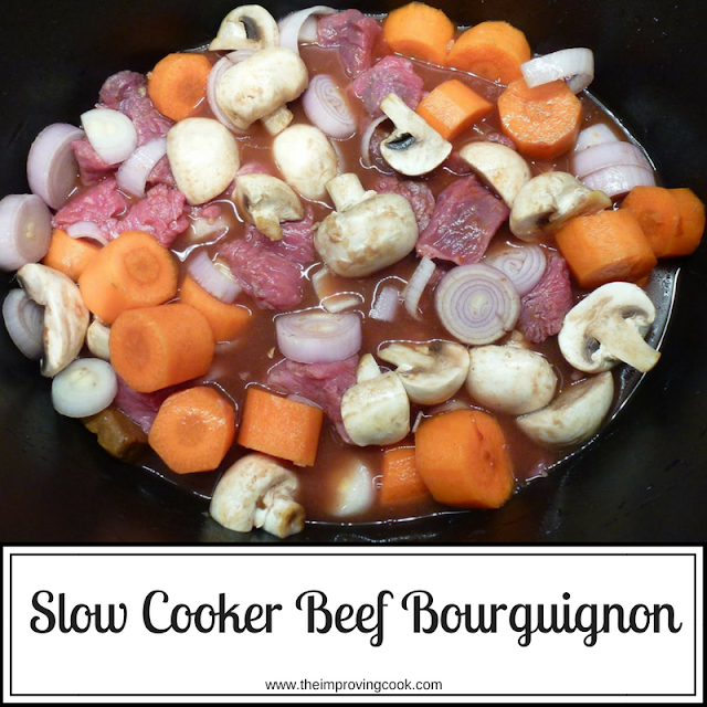 Raw ingredients for beef bourguignon in a slow cooker