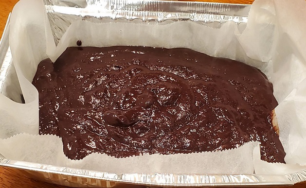 batter for brownies in disposable pan
