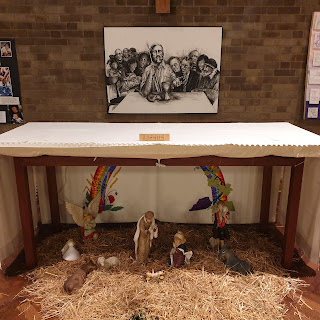 Image description 1: An altar behind which is a drawing of a blind Jesus welcoming all to the Lord's Supper.