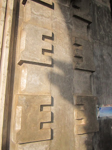 Pillars of the ruins with the initial M facing each other