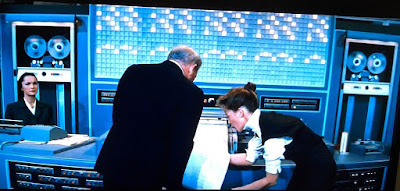 Still from 1957 movie 'Desk Set' Ms. Watson looks at an IBM EMARAC's line printer answer to a question submitted via punch cards