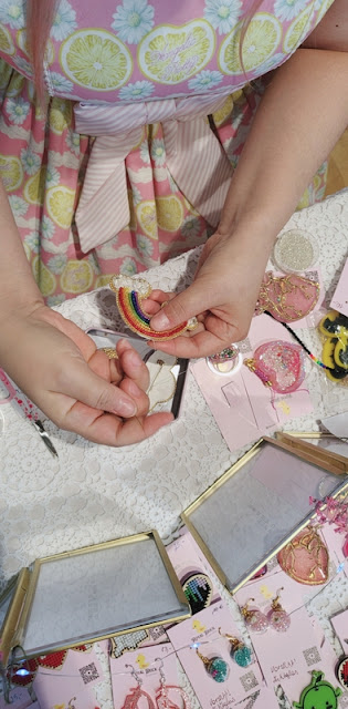 picture of hands embroidering a rainbow