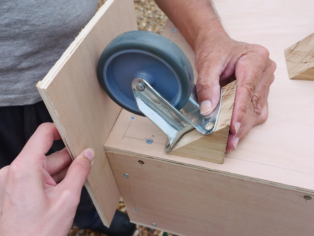 Creating a triangular block to attach castor wheels to the box.