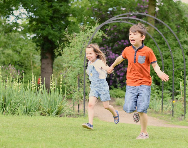 Brother and sister running in the park  