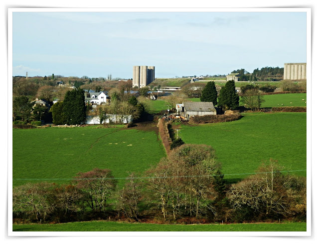 Green fields with a china clay works in the background, St.Austell