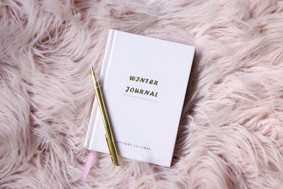 a cute white journal on top of a pink furry rug