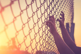 s320/stock-photo-60649746-hand-holding-on-chain-link-fence