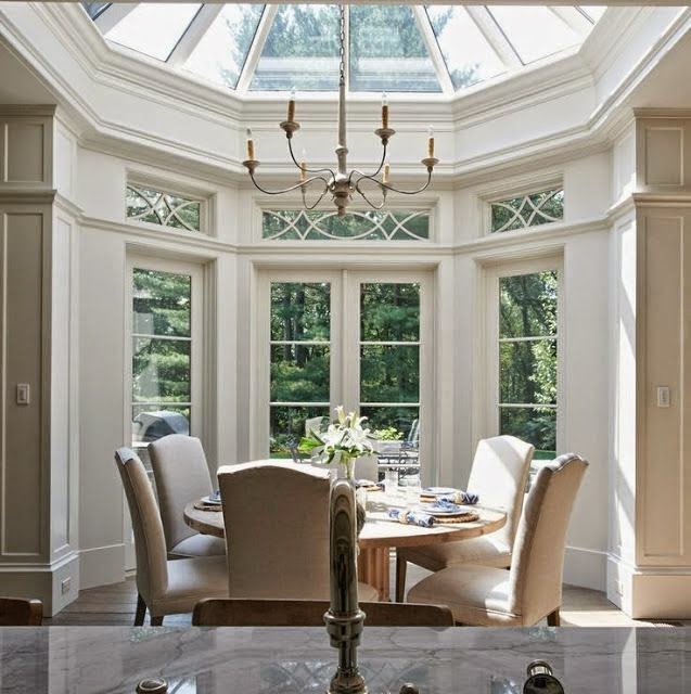beautiful traditional dining room design with two story windows round table parsons chairs