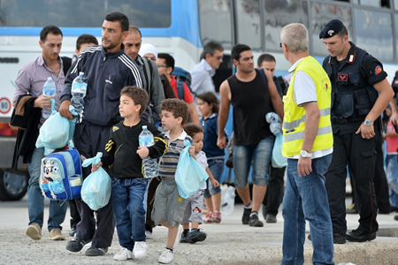 Diverse persone prima di essere imbarcate per la Sicilia