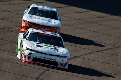 Tyler Reddick (#9 BurgerFi Chevrolet) leads Spencer Gallagher.