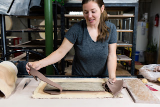 Bethany Kramer handbuilding a "taco plate" serving tray.