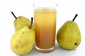 Pear juice in a glass and some pears