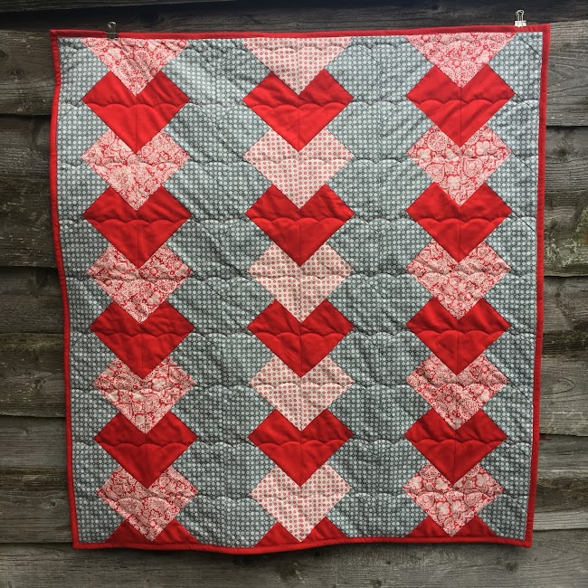 red and grey braid quilt