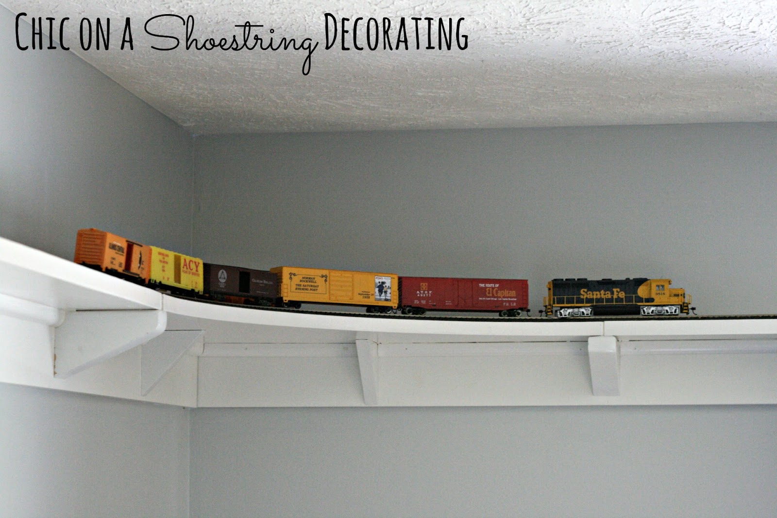 DIY HO Train track shelf around room ceiling by Chic on a Shoestring