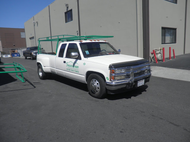 Fleet vehicles repainted with company colors and graphics at Almost Everything Auto Body