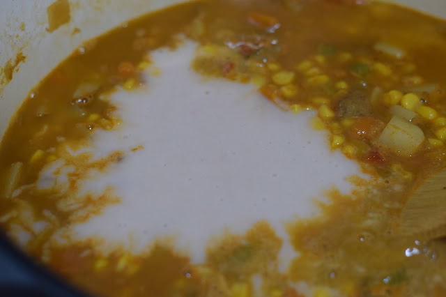 The blended beans being added to the pot.