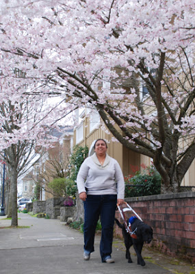 Amelia and Guide Dog Valeria walk down the street