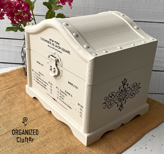 Photo of a wooden treasure chest makeover with paint and decor transfers.