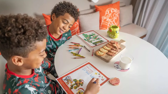 Two children coloring in Nickelodeon holiday pictures