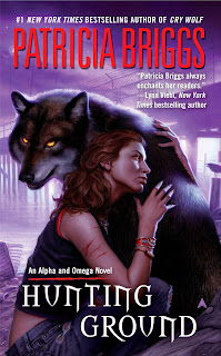 A woman with scratches on one arm embraces a wolf with glowing yellow eyes
