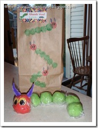 Goody bag decorated by party guests and filled with homemade kool aid playdough made to look like hungry caterpillar