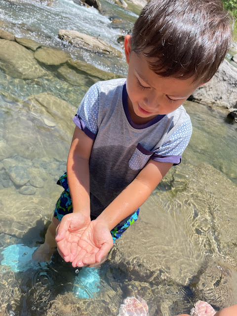 boy holding fish in his hand