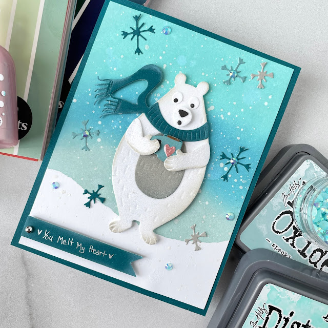 Polar Bear Christmas card made with: Tim Holtz distress oxide inks, cosy winter Sizzix die, frosted crystal embossing powder; Scrapbook.com A2 smooth cardstock, mint tape, frost metallic ink, Pops of Color rose gold; Pinkfresh jewels