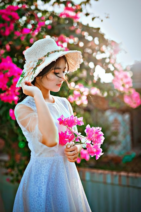 woman-wearing-sun-hat-and-white-dress-flowers-pink