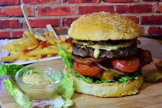 image of a cheeseburger fries sauce food