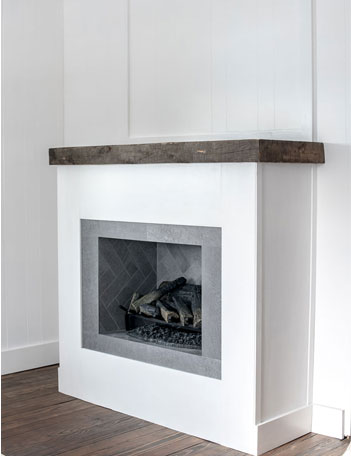 white fireplace with wood mantel